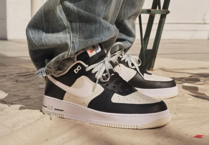 Nike Air Force 1 in Schwarz-Weiß. Die Frage, wie fallen Nike Air Force 1 aus, wird hier durch den lässigen Look mit Jeans beantwortet.