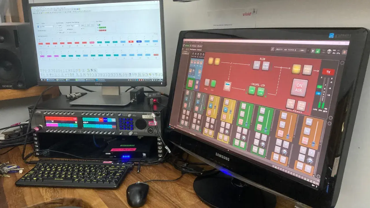 Ein gig performer steuert mit zwei Monitoren und einem Rack-Mixer die Audioübertragung.